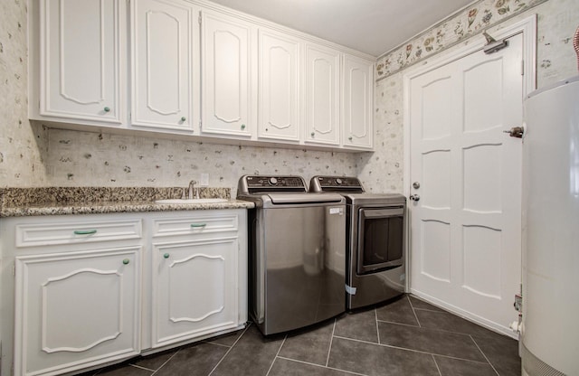 10523 Fawnview Dr, Houston, TX 77070 - laundry room featuring wallpapered walls, dark tile patterned flooring, separate washer and dryer, and cabinet space