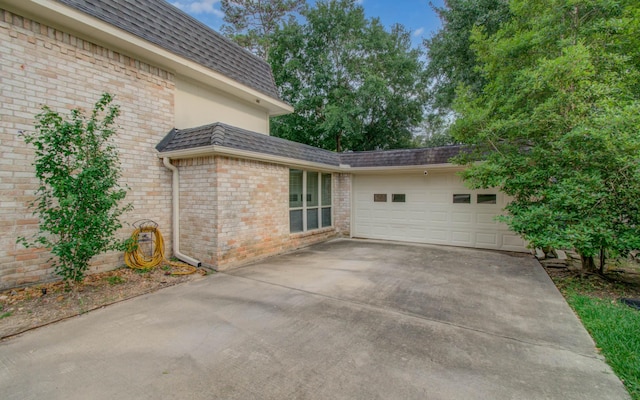 10523 Fawnview Dr, Houston, TX 77070 - view of patio / terrace with an attached garage and driveway