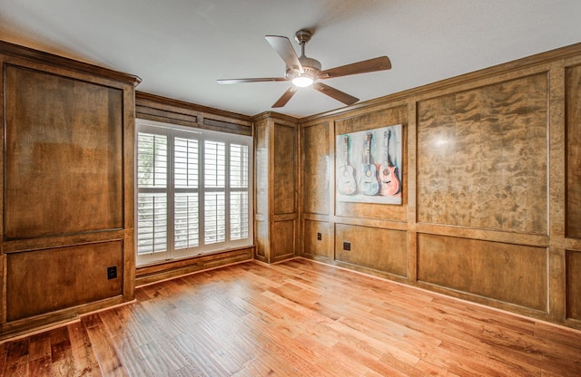 10523 Fawnview Dr, Houston, TX 77070 - spare room featuring a ceiling fan, light wood-style flooring, crown molding, and a decorative wall