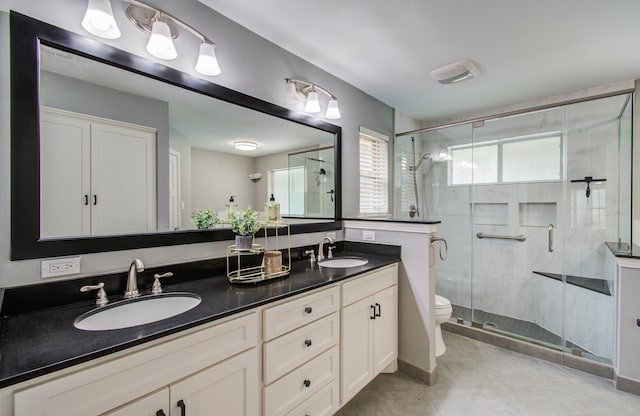 10523 Fawnview Dr, Houston, TX 77070 - full bathroom featuring toilet, double vanity, a shower stall, and tile patterned floors