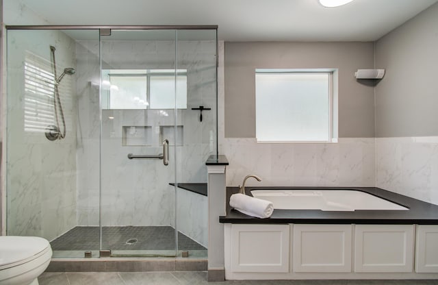 10523 Fawnview Dr, Houston, TX 77070 - bathroom with toilet, a marble finish shower, a bath, tile walls, and tile patterned flooring