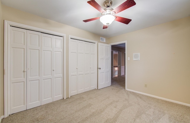 10523 Fawnview Dr, Houston, TX 77070 - unfurnished bedroom with carpet flooring, two closets, baseboards, and ceiling fan