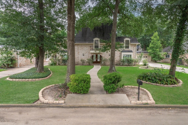 10523 Fawnview Dr, Houston, TX 77070 - french provincial home with french doors, brick siding, a front yard, roof with shingles, and driveway