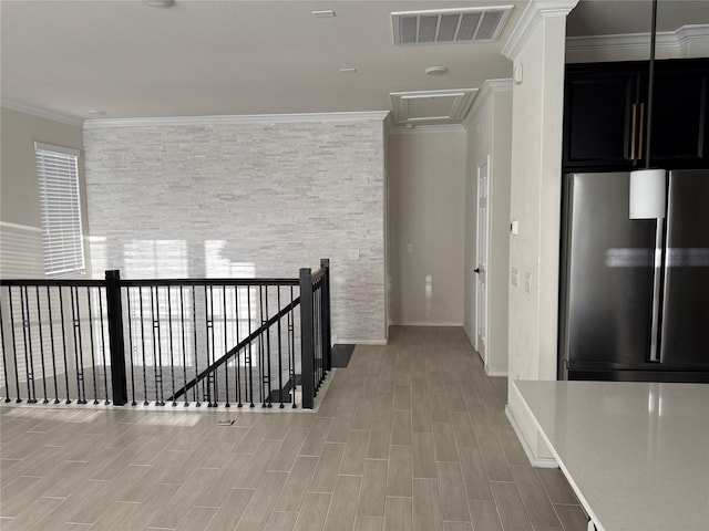 10307 Harmon Smith Dr, Houston, TX 77025 - hallway with crown molding, an upstairs landing, and light wood-type flooring