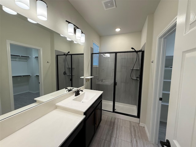 10307 Harmon Smith Dr, Houston, TX 77025 - bathroom featuring a spacious closet, a shower stall, vanity, and recessed lighting