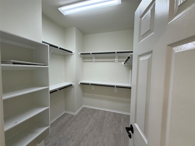10307 Harmon Smith Dr, Houston, TX 77025 - walk in closet with wood finished floors