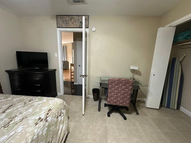 8100 Cambridge St Unit 30, Houston, TX 77054 - tiled bedroom featuring an office area and baseboards