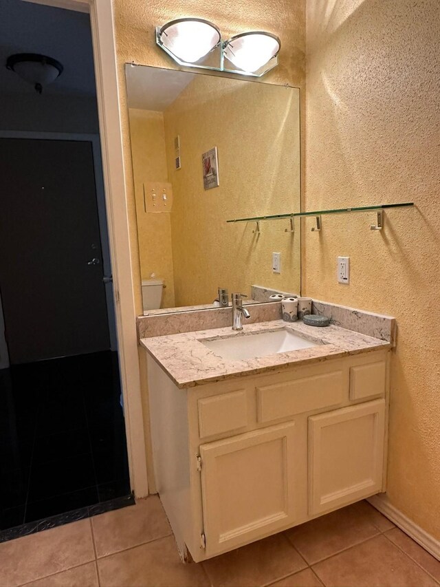 8100 Cambridge St Unit 30, Houston, TX 77054 - bathroom with tile patterned floors, vanity, and a textured wall