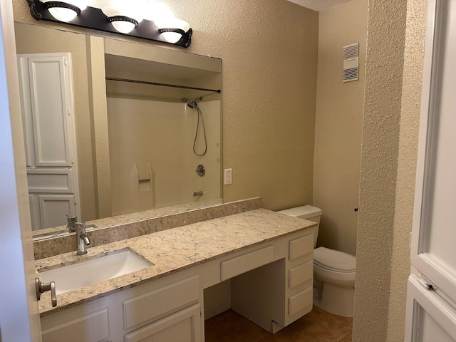 8100 Cambridge St Unit 30, Houston, TX 77054 - full bathroom with tile patterned floors, toilet, a textured wall, vanity, and a shower