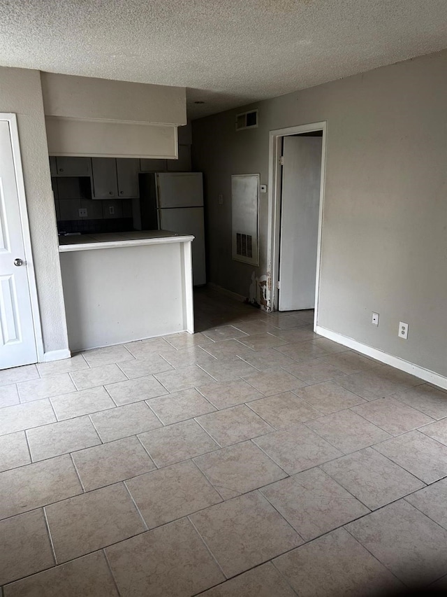 12615 Brookglade Cir Unit 407, Houston, TX 77099 - unfurnished living room featuring a textured ceiling and baseboards
