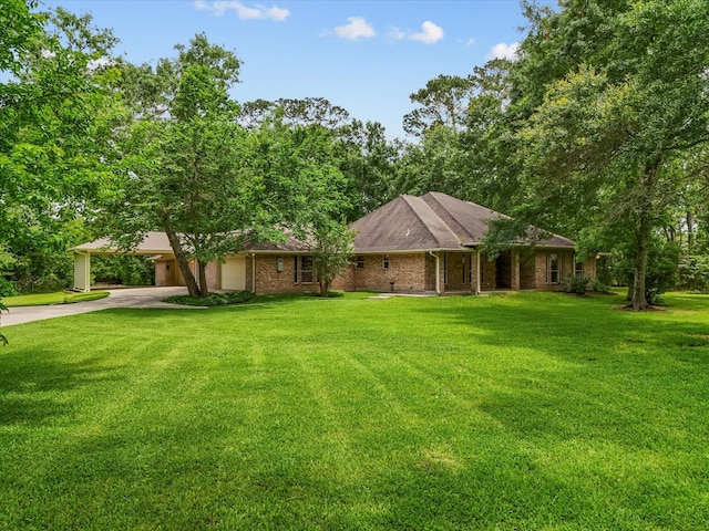 5401 Palm Dr, Dickinson, TX 77539 - view of front facade with driveway, an attached garage, a front lawn, and brick siding