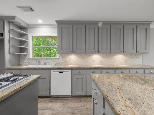 5401 Palm Dr, Dickinson, TX 77539 - kitchen featuring white dishwasher, gray cabinets, a sink, light wood-type flooring, and backsplash