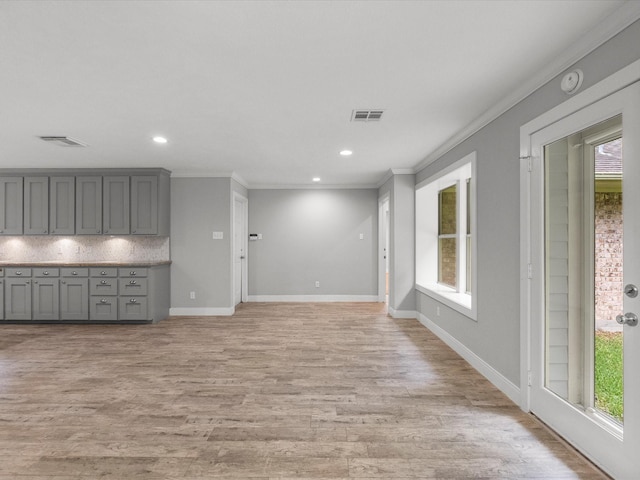 5401 Palm Dr, Dickinson, TX 77539 - unfurnished living room with crown molding, healthy amount of natural light, light wood finished floors, and recessed lighting