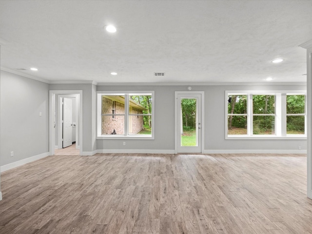 5401 Palm Dr, Dickinson, TX 77539 - unfurnished living room featuring crown molding, healthy amount of natural light, baseboards, recessed lighting, and light wood-style flooring
