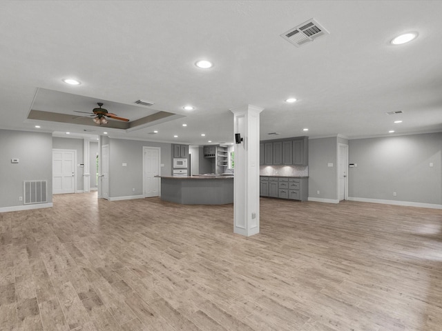 5401 Palm Dr, Dickinson, TX 77539 - unfurnished living room with baseboards, recessed lighting, a raised ceiling, ceiling fan, and light wood finished floors