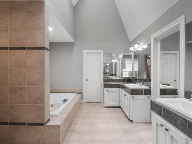 5401 Palm Dr, Dickinson, TX 77539 - bathroom with a tub with jets, vanity, tile patterned floors, and high vaulted ceiling