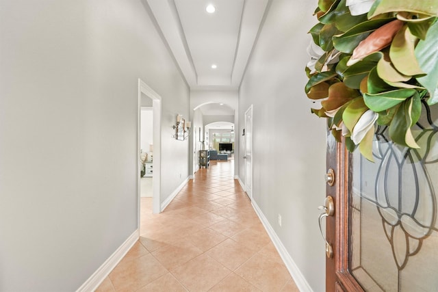 31815 Forest Oak Ln, Conroe, TX 77385 - hall featuring arched walkways, light tile patterned floors, recessed lighting, baseboards, and a towering ceiling