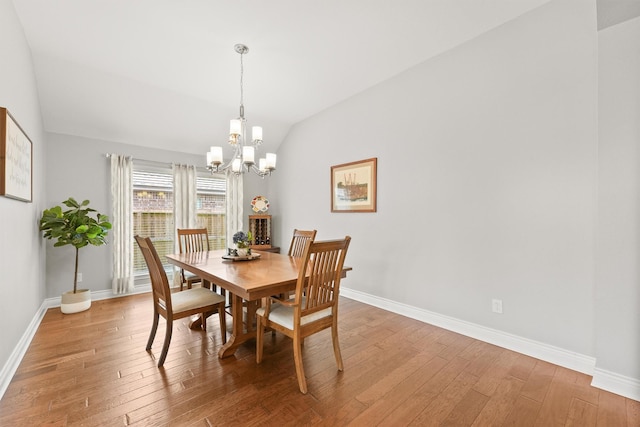 31815 Forest Oak Ln, Conroe, TX 77385 - dining room with vaulted ceiling, light wood finished floors, a chandelier, and baseboards