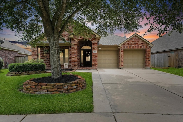 31815 Forest Oak Ln, Conroe, TX 77385 - traditional-style home with brick siding, a garage, driveway, and a shingled roof