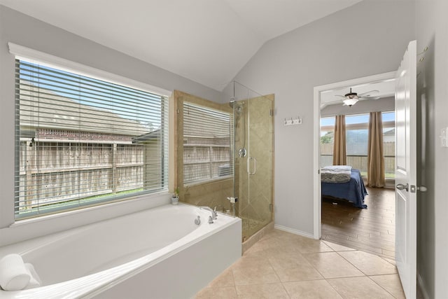 31815 Forest Oak Ln, Conroe, TX 77385 - ensuite bathroom featuring lofted ceiling, a bath, a stall shower, tile patterned flooring, and baseboards