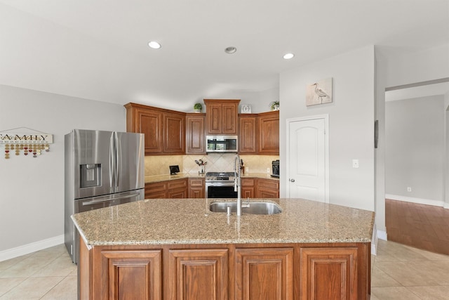 31815 Forest Oak Ln, Conroe, TX 77385 - kitchen with stainless steel appliances, baseboards, brown cabinetry, backsplash, and recessed lighting