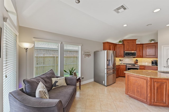 31815 Forest Oak Ln, Conroe, TX 77385 - kitchen with stainless steel appliances, a sink, tasteful backsplash, light stone countertops, and vaulted ceiling