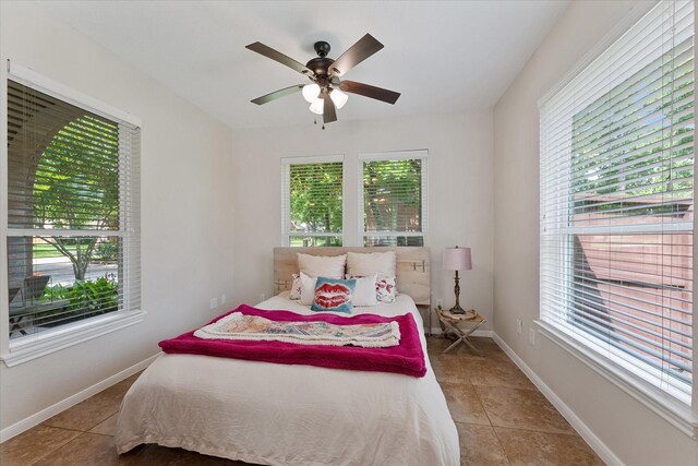 14102 Pollux Ct, Tomball, TX 77375 - bedroom with tile patterned floors, baseboards, and ceiling fan