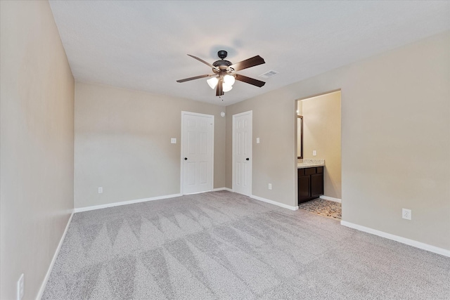 14102 Pollux Ct, Tomball, TX 77375 - unfurnished bedroom with light carpet, baseboards, connected bathroom, and a ceiling fan