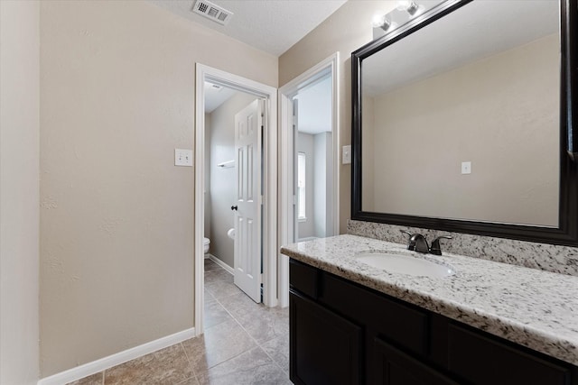 14102 Pollux Ct, Tomball, TX 77375 - bathroom featuring vanity, toilet, tile patterned flooring, and baseboards