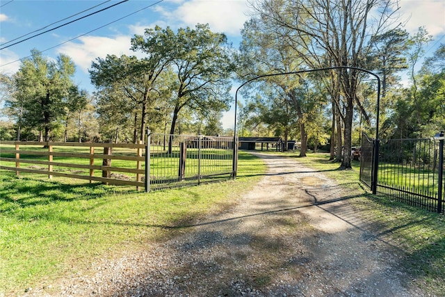 14232 Calhoun Rd, Conroe, TX 77302 - view of dirt / gravel road with a gated entry and a gate