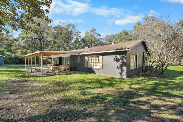 14232 Calhoun Rd, Conroe, TX 77302 - back of property featuring brick siding, a patio area, and a yard
