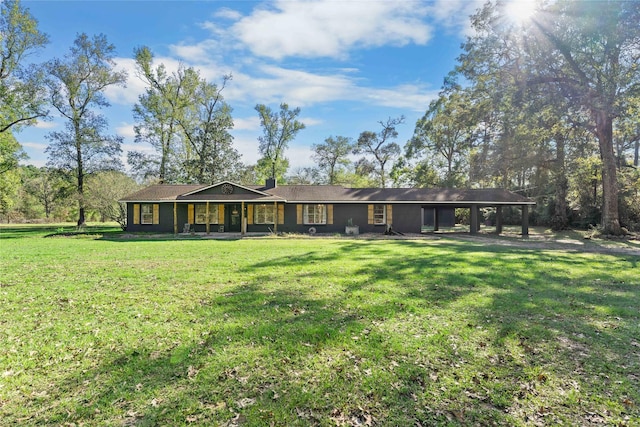14232 Calhoun Rd, Conroe, TX 77302 - view of front facade with a front lawn, a chimney, a porch, and an attached carport