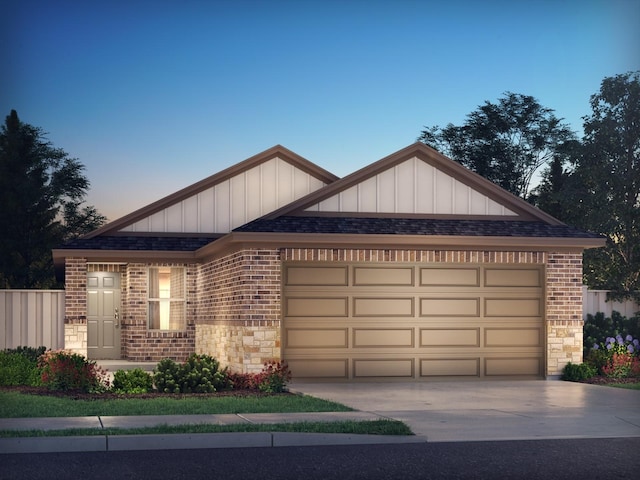 18733 Bliss Pl, New Caney, TX 77357 - view of front of home with brick siding, a garage, driveway, stone siding, and board and batten siding