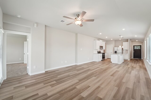 18733 Bliss Pl, New Caney, TX 77357 - unfurnished living room featuring ceiling fan, light wood-style floors, recessed lighting, and baseboards
