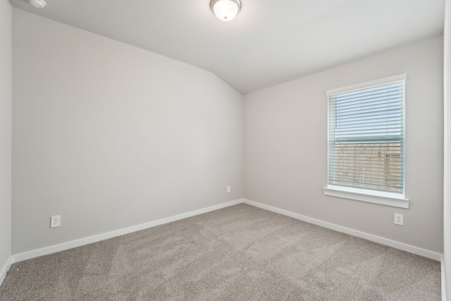 18733 Bliss Pl, New Caney, TX 77357 - empty room featuring carpet flooring, lofted ceiling, and baseboards