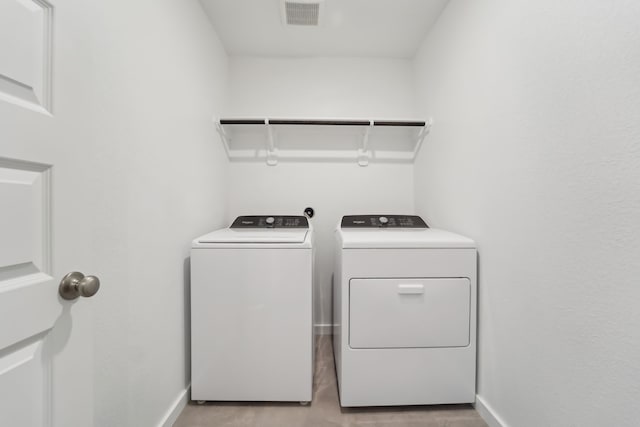 18733 Bliss Pl, New Caney, TX 77357 - laundry area with separate washer and dryer, baseboards, and light wood-type flooring