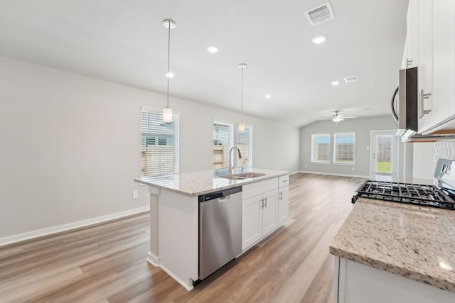 18733 Bliss Pl, New Caney, TX 77357 - kitchen featuring appliances with stainless steel finishes, a sink, light wood-type flooring, white cabinetry, and recessed lighting