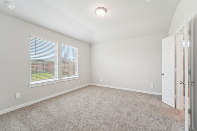 18733 Bliss Pl, New Caney, TX 77357 - unfurnished bedroom featuring carpet, baseboards, and vaulted ceiling