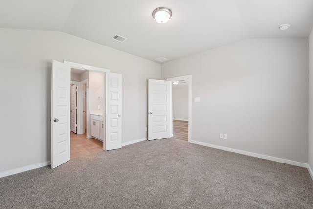 18733 Bliss Pl, New Caney, TX 77357 - unfurnished bedroom featuring vaulted ceiling, light carpet, and baseboards