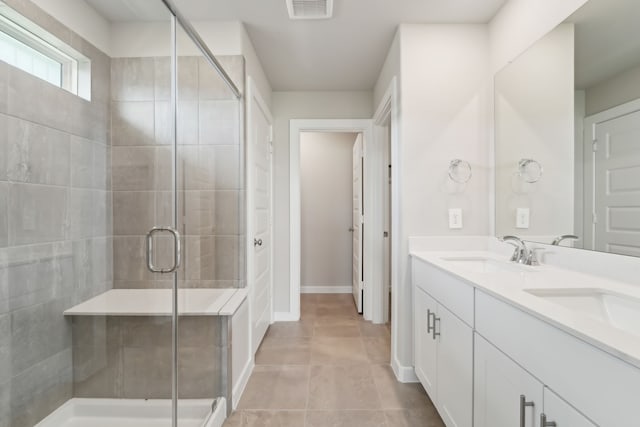 18733 Bliss Pl, New Caney, TX 77357 - full bath featuring double vanity, a shower stall, tile patterned floors, and baseboards