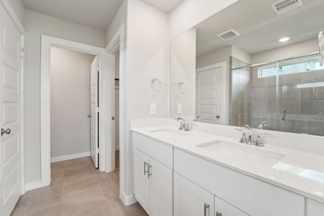 18733 Bliss Pl, New Caney, TX 77357 - full bath with double vanity, a shower stall, tile patterned floors, and baseboards