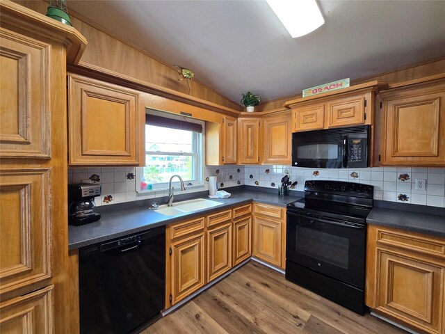 16611 Jolly Roger Rd, Jamaica Beach, TX 77554 - kitchen with black appliances, a sink, dark countertops, decorative backsplash, and lofted ceiling
