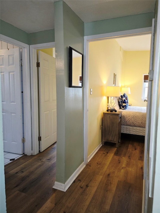 16611 Jolly Roger Rd, Jamaica Beach, TX 77554 - hallway featuring dark wood-style floors and baseboards