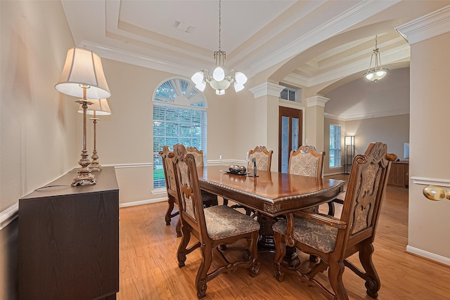 2403 Crescent Hollow Ct, Spring, TX 77388 - dining space with decorative columns, a raised ceiling, arched walkways, light wood-style floors, and ornamental molding