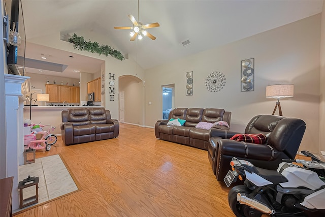 2403 Crescent Hollow Ct, Spring, TX 77388 - living room with ceiling fan, arched walkways, light wood-type flooring, and high vaulted ceiling