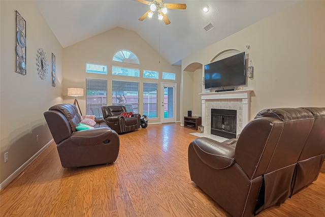 2403 Crescent Hollow Ct, Spring, TX 77388 - living area with ceiling fan, light wood-style floors, a fireplace, baseboards, and high vaulted ceiling