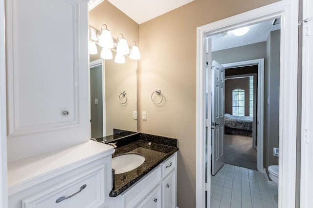 17718 Dove Tree Ln, Spring, TX 77379 - bathroom with tile patterned floors, vanity, toilet, a chandelier, and ensuite bath
