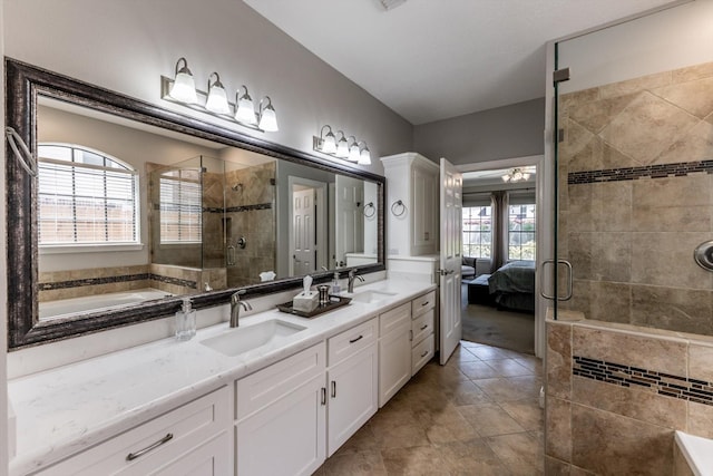 17718 Dove Tree Ln, Spring, TX 77379 - ensuite bathroom featuring a stall shower, double vanity, tile patterned flooring, and a ceiling fan