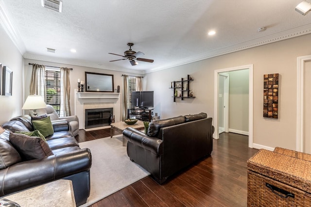 17718 Dove Tree Ln, Spring, TX 77379 - living area featuring crown molding, a ceiling fan, a glass covered fireplace, dark wood finished floors, and recessed lighting