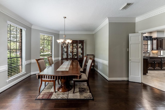 17718 Dove Tree Ln, Spring, TX 77379 - dining area featuring a chandelier, wood finished floors, baseboards, and crown molding
